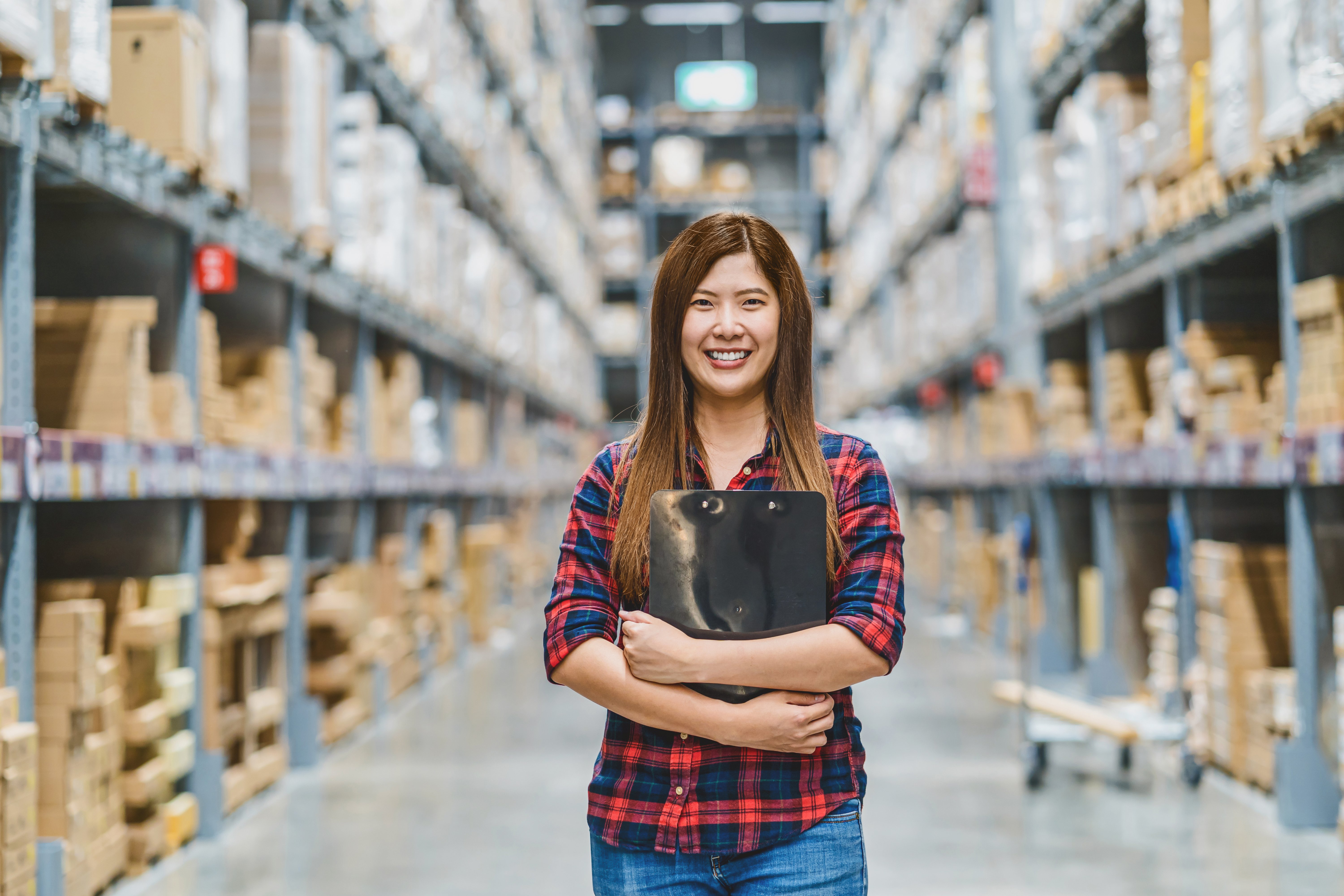 Happy female warehouse employee