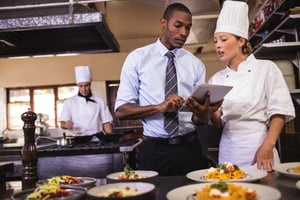 Hotel manager talking with chef