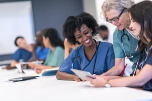 Students learning from experienced nurse