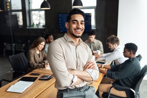 Young man smiling in conference room