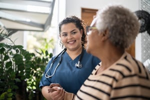 Nurse with senior patient smiling