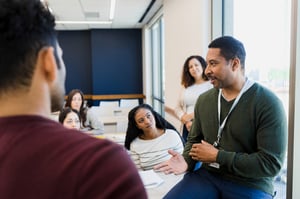 Teacher discussing business with students