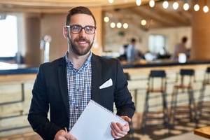 Smiling male restaurant manager